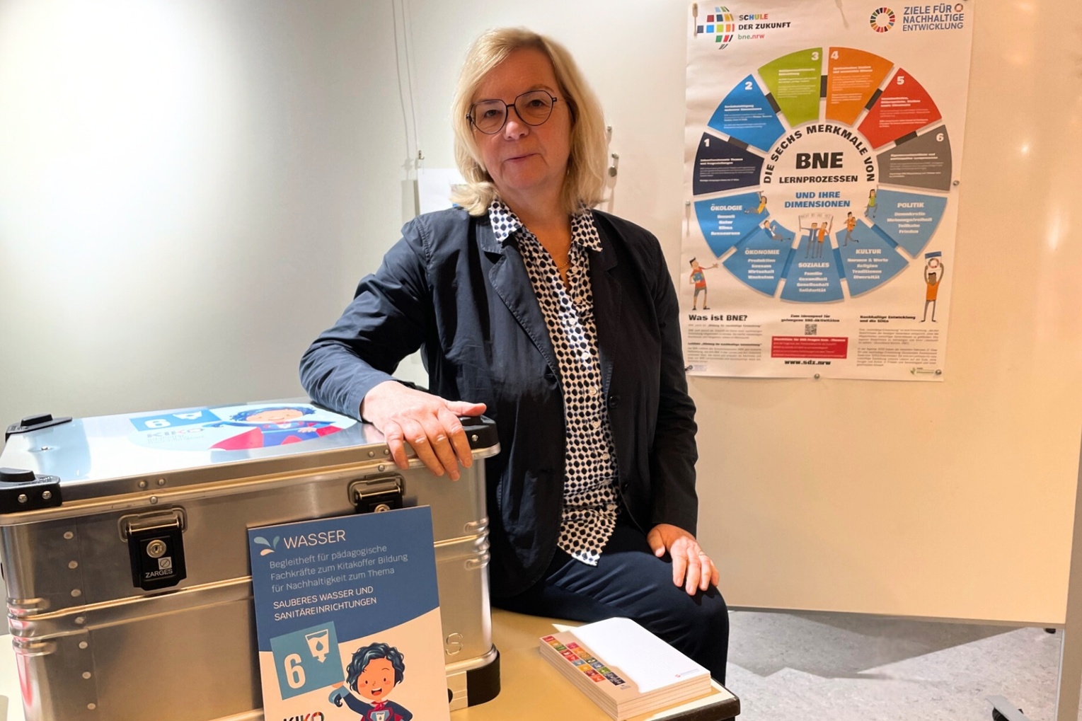 Prof. Dr. Ute Harms pictured alongside the new resource and activity kit on education for sustainability at the first training event for potential users, November 13, 2024